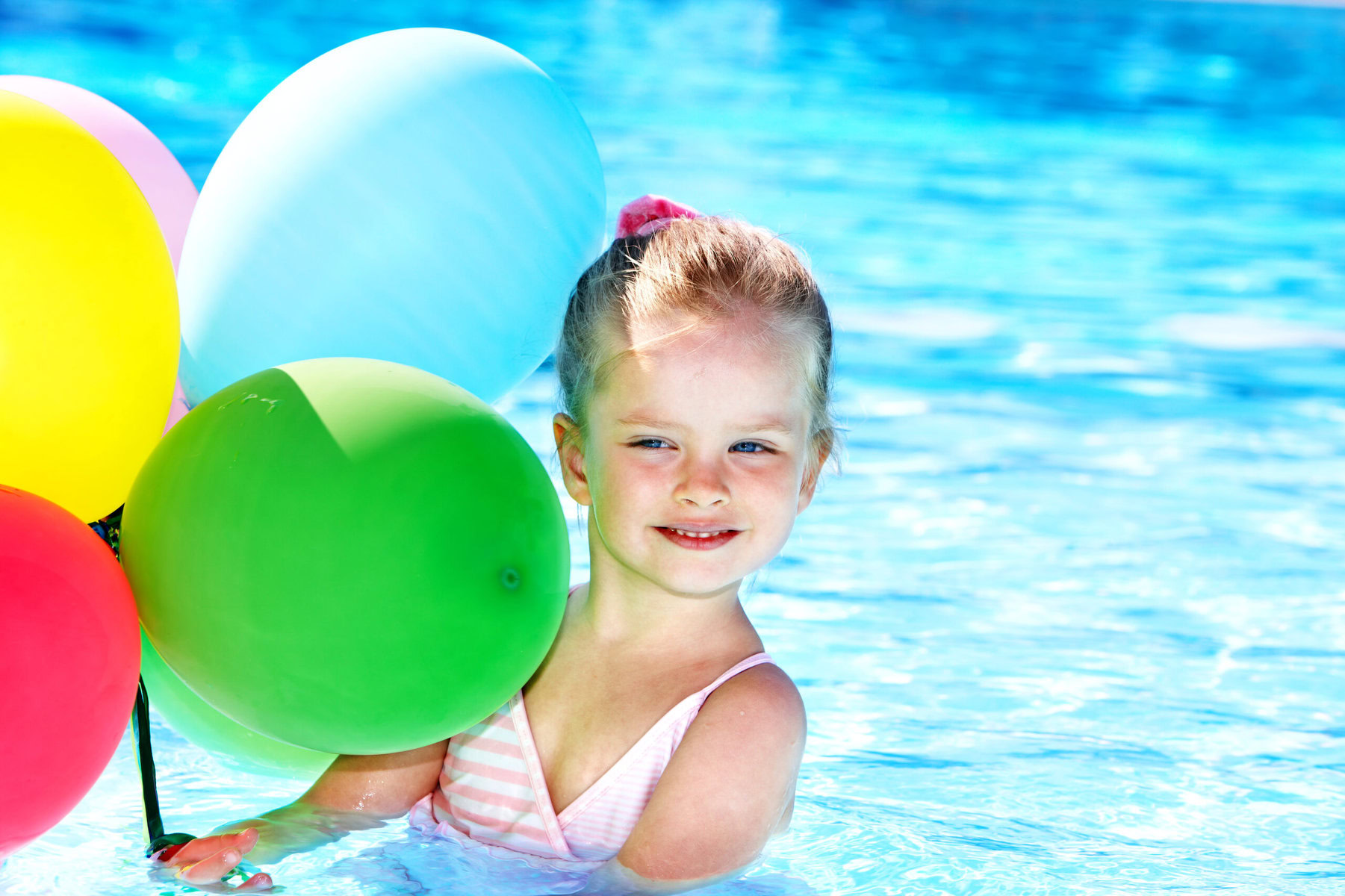 Little,Girl,Playing,With,Balloons,In,Swimming,Pool.
